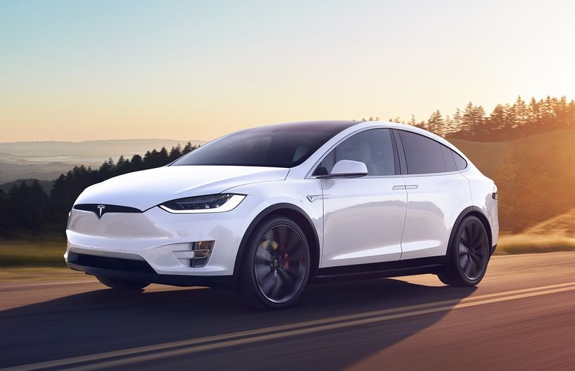 White Tesla Model X driving 